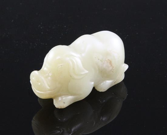 A Chinese pale celadon jade figure of a recumbent pig, 19th century, 5.6cm